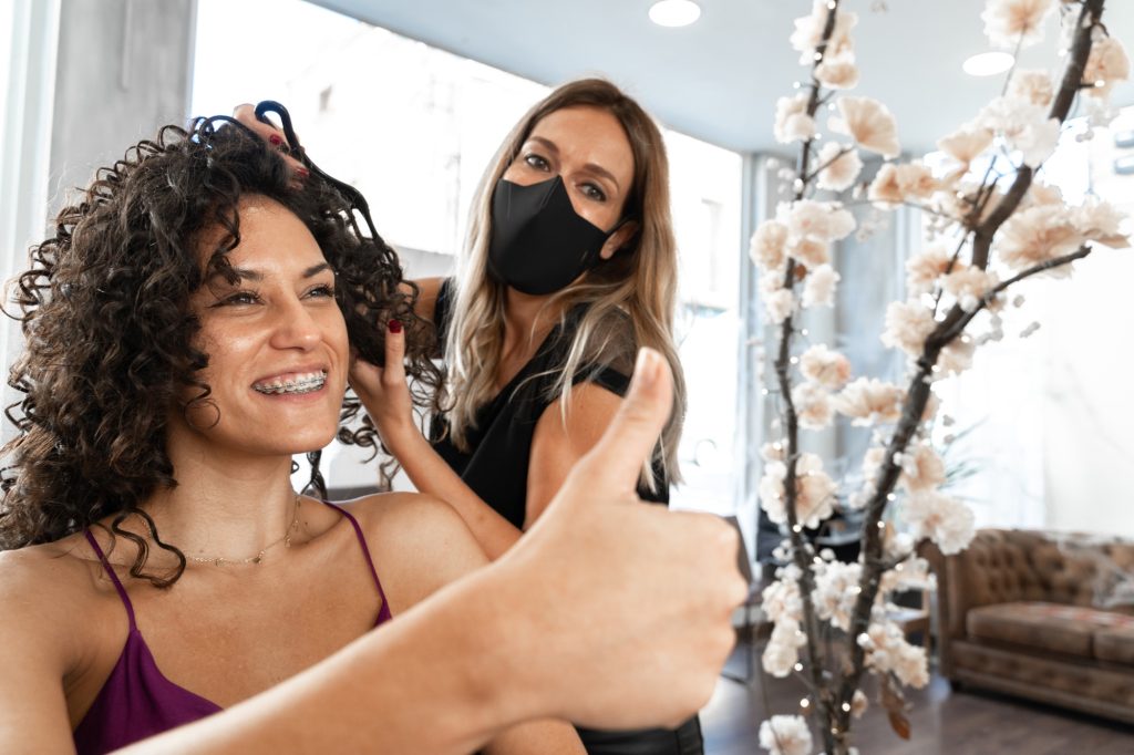 Une femme chez le coiffeur et souriante